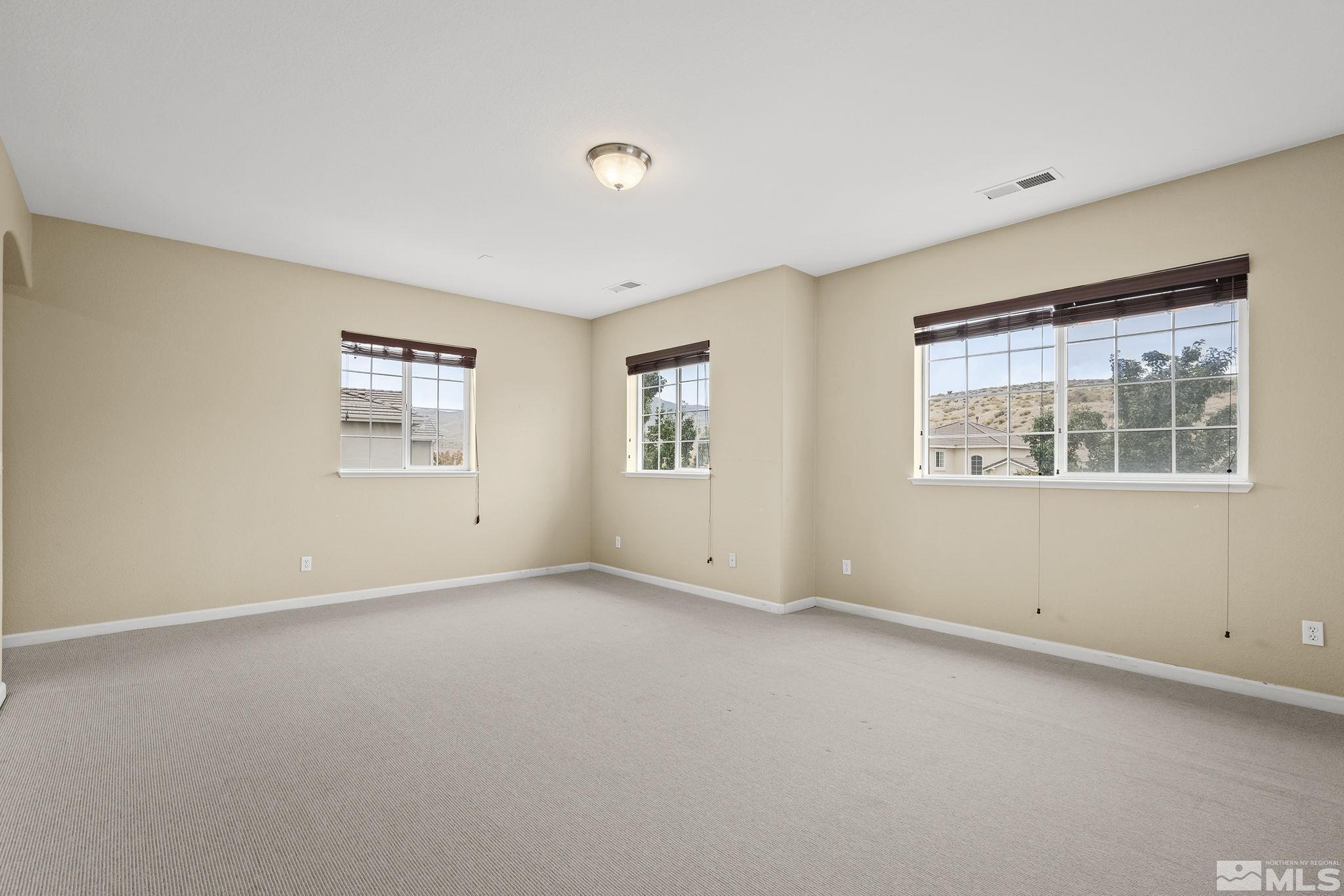 7144 Crest Hill Drive Reno, NV 89506 - Photo 11 of 28 an empty room with windows