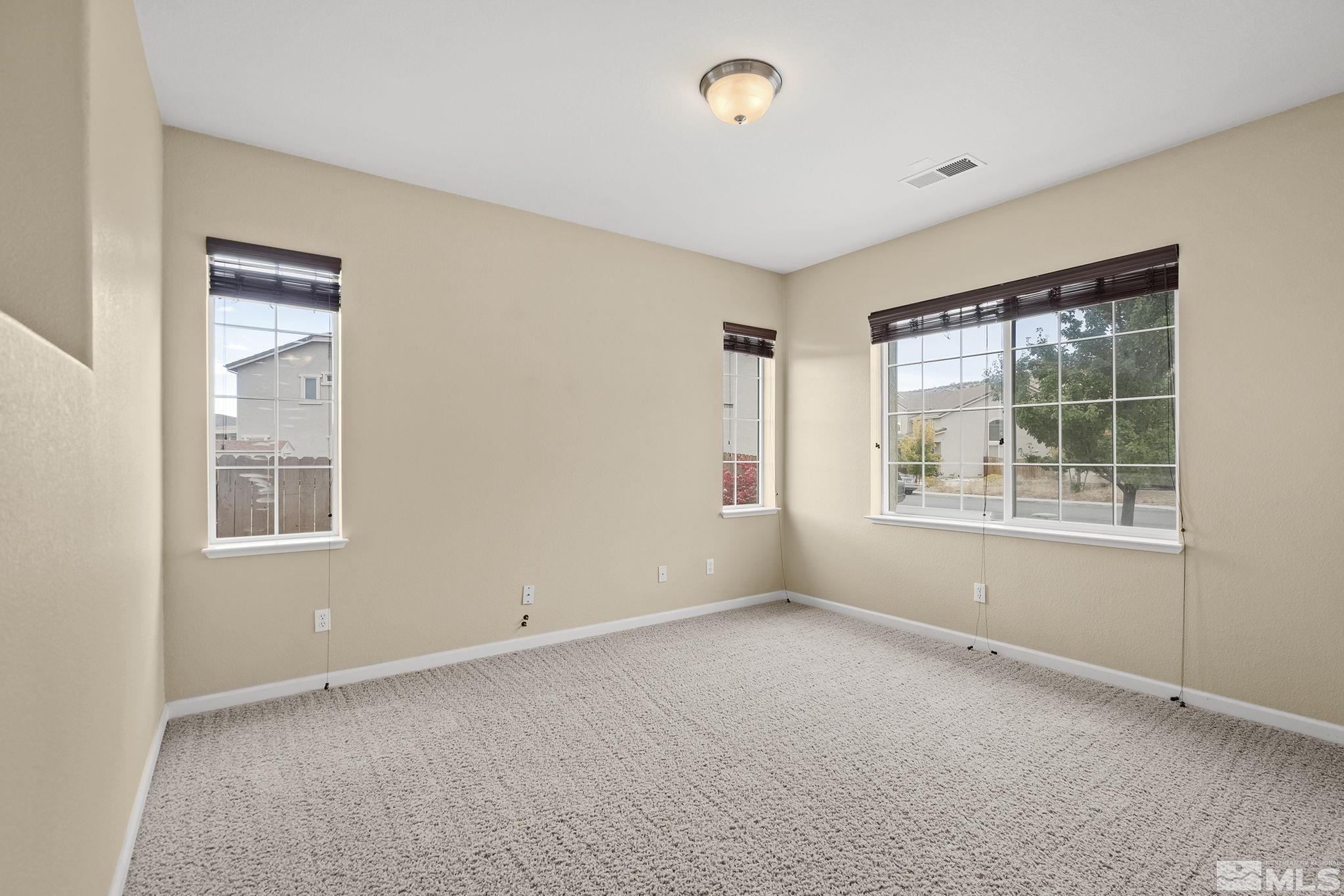 7144 Crest Hill Drive Reno, NV 89506 - Photo 12 of 28 an empty room with windows