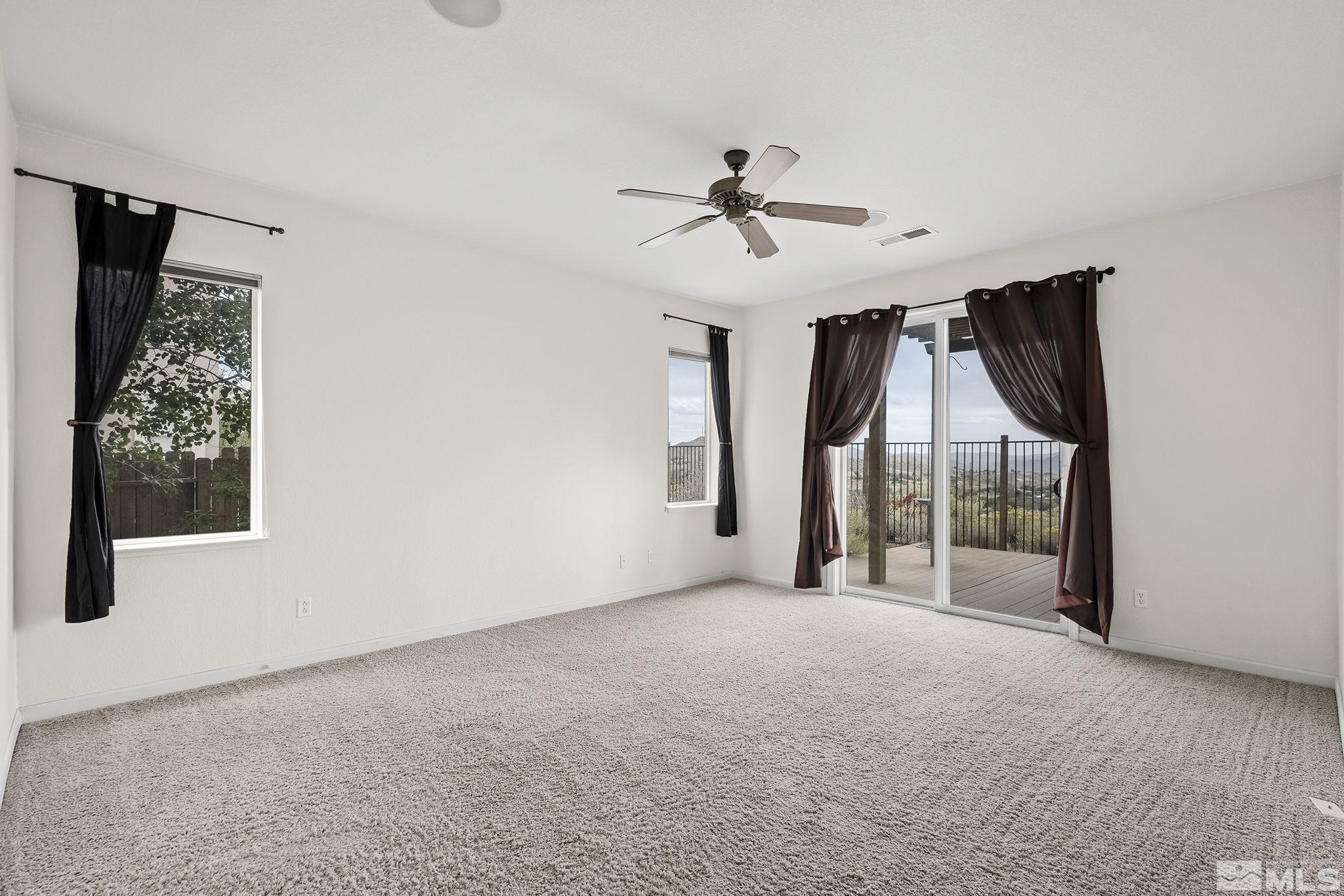 7144 Crest Hill Drive Reno, NV 89506 - Photo 14 of 28 a view of a big room with windows and ceiling fan
