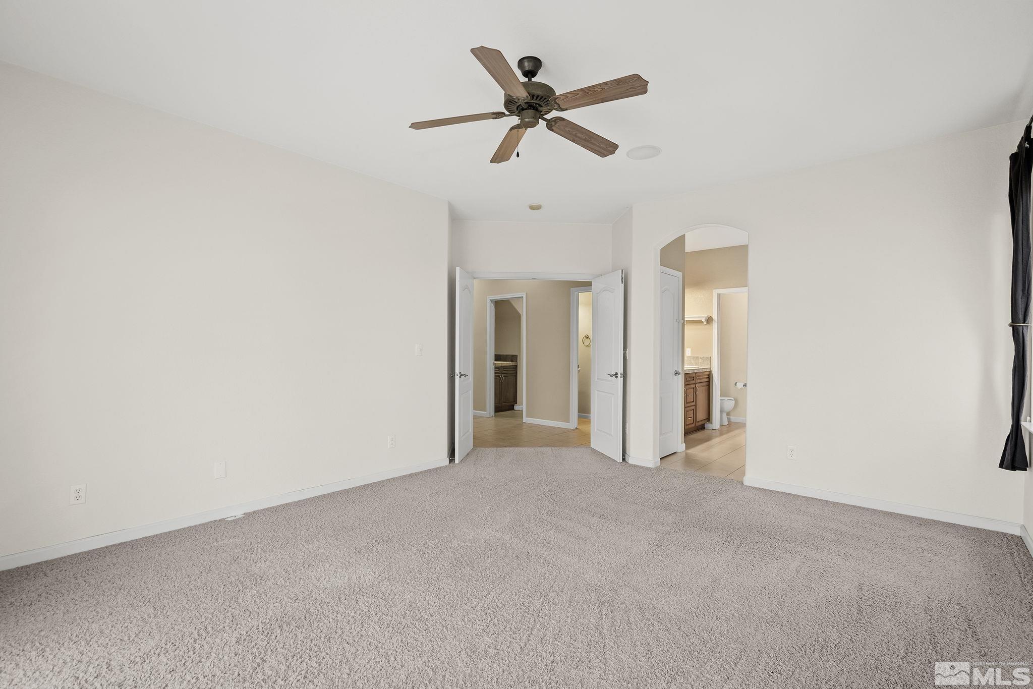 7144 Crest Hill Drive Reno, NV 89506 - Photo 16 of 28 a view of a livingroom with a ceiling fan and window