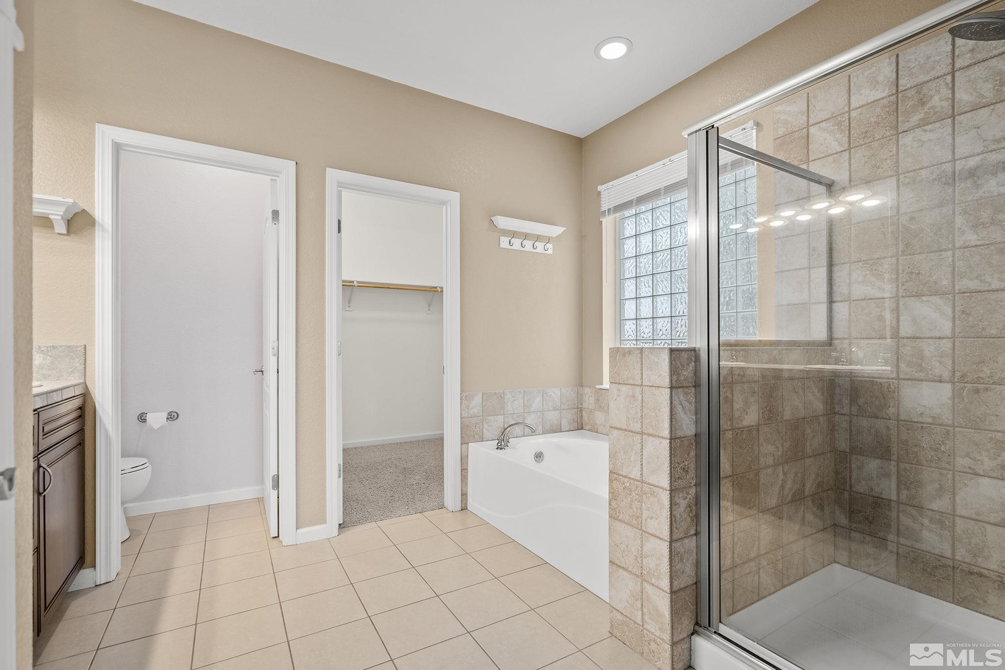 7144 Crest Hill Drive Reno, NV 89506 - Photo 18 of 28 a bathroom with a shower and toilet
