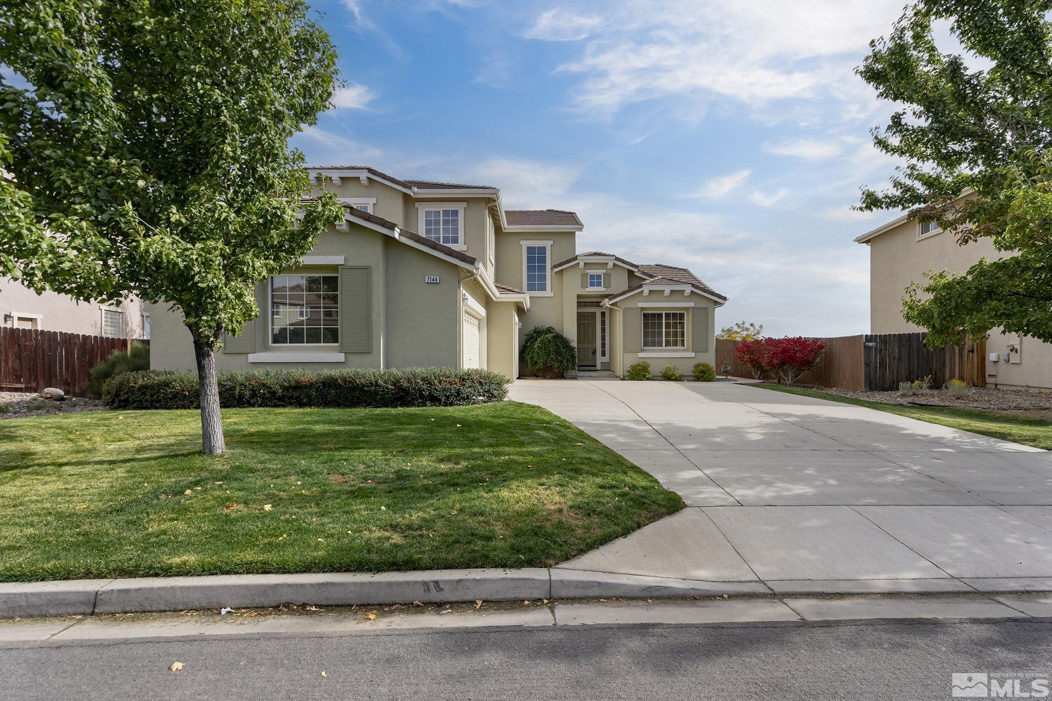 7144 Crest Hill Drive Reno, NV 89506 - Photo 2 of 28 a front view of house with yard and green space