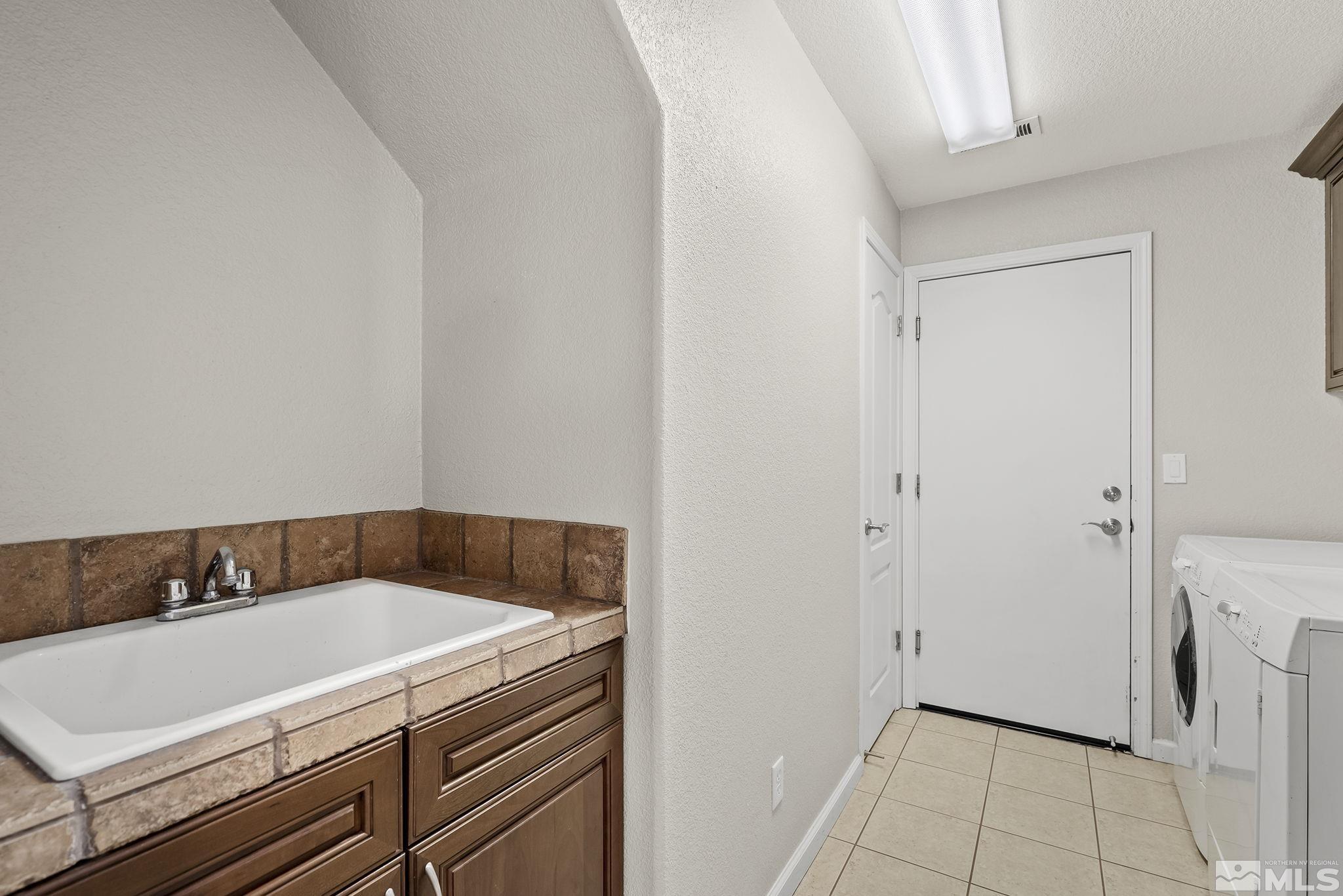 7144 Crest Hill Drive Reno, NV 89506 - Photo 23 of 28 a utility room with a sink