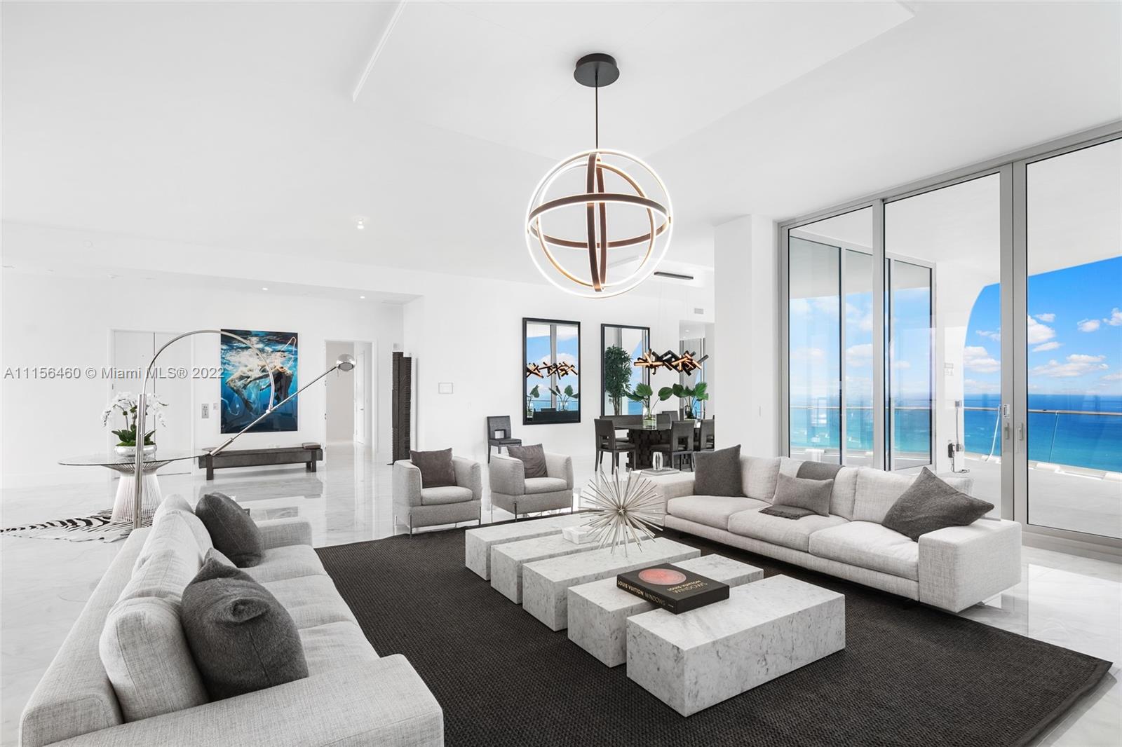 a living room with furniture a couch and large window