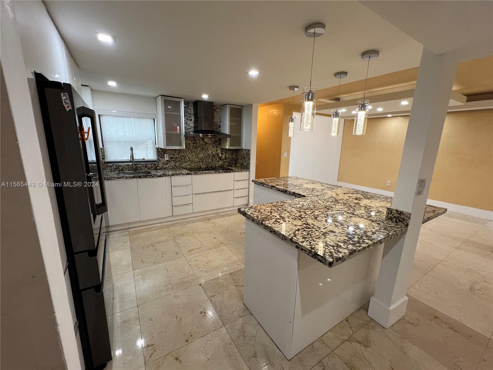 California Club Miami, FL 33179 - Photo 13 of 21 a kitchen with stainless steel appliances granite countertop a sink stove and refrigerator