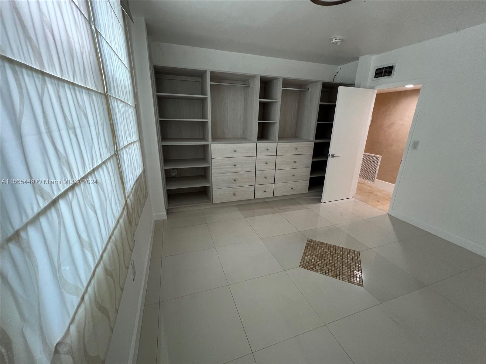 California Club Miami, FL 33179 - Photo 15 of 21 a view of walk in closet with empty racks