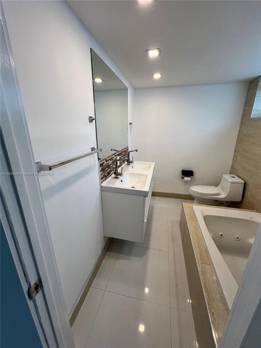 California Club Miami, FL 33179 - Photo 20 of 21 a bathroom with a sink a tub and a mirror