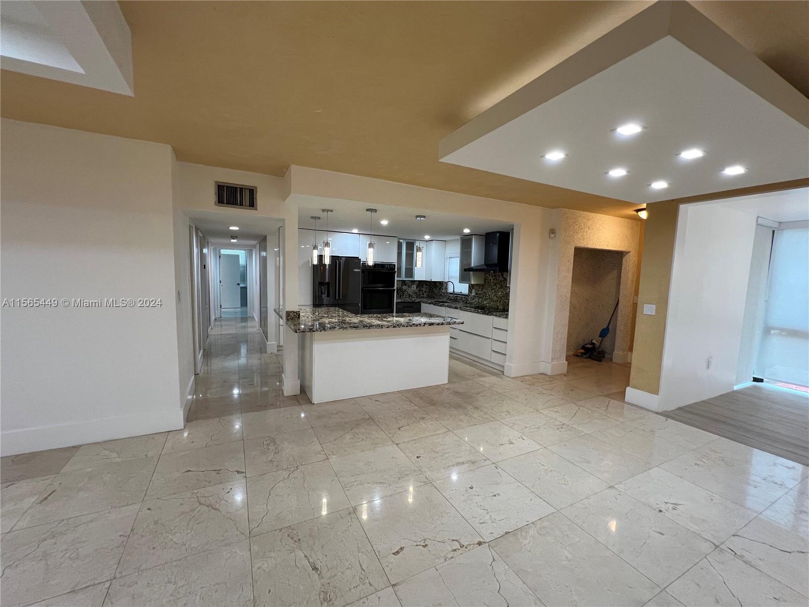 California Club Miami, FL 33179 - Photo 9 of 21 a view of a kitchen with refrigerator and white cabinets