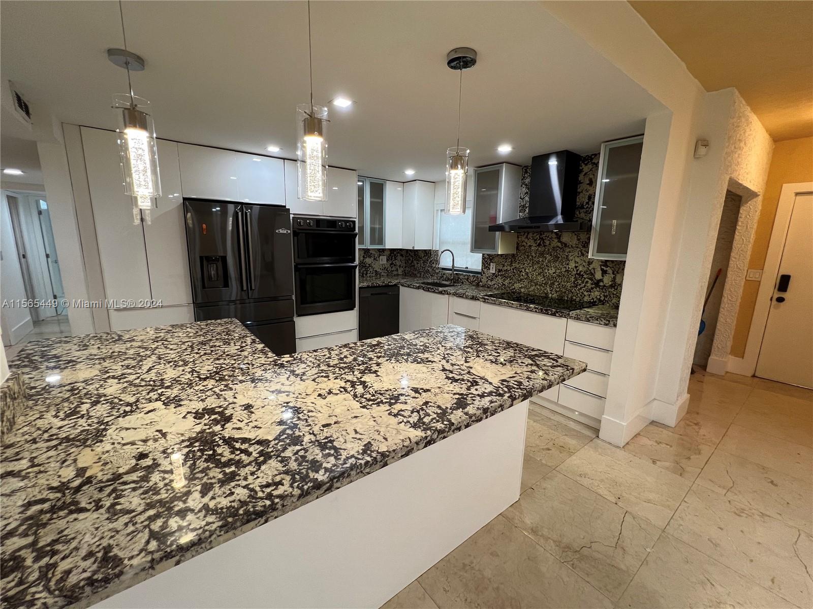 California Club Miami, FL 33179 - Photo 10 of 21 a kitchen with stainless steel appliances kitchen island granite countertop a refrigerator and a sink