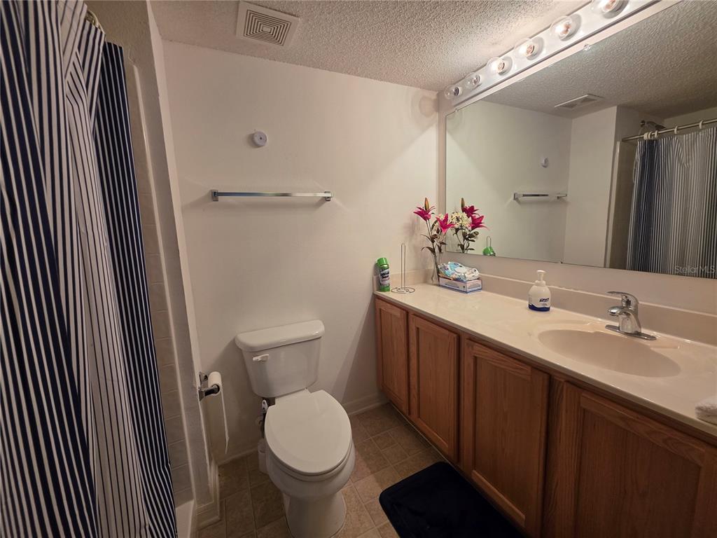 9276 Elm Court Spring Hill, FL 34606 - Photo 12 of 35 a bathroom with a sink and a mirror