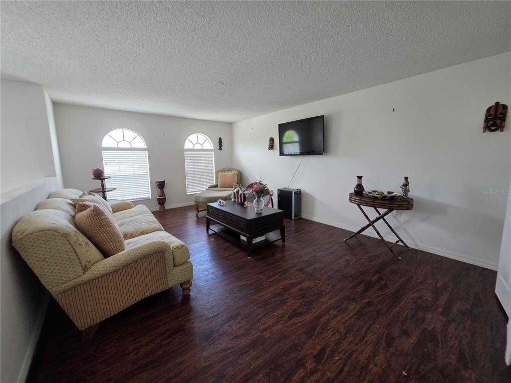 9276 Elm Court Spring Hill, FL 34606 - Photo 14 of 35 a living room with furniture window and a wooden floor