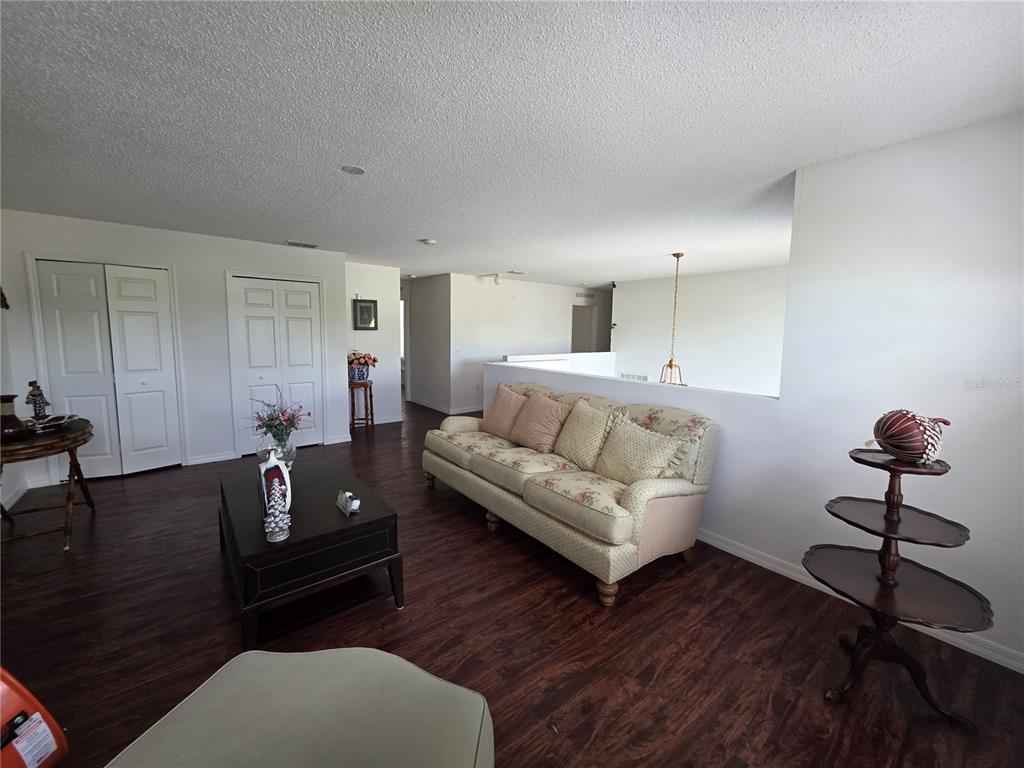 9276 Elm Court Spring Hill, FL 34606 - Photo 15 of 35 a living room with furniture and wooden floor