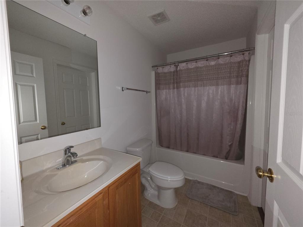 9276 Elm Court Spring Hill, FL 34606 - Photo 18 of 35 a bathroom with a granite countertop sink toilet and shower
