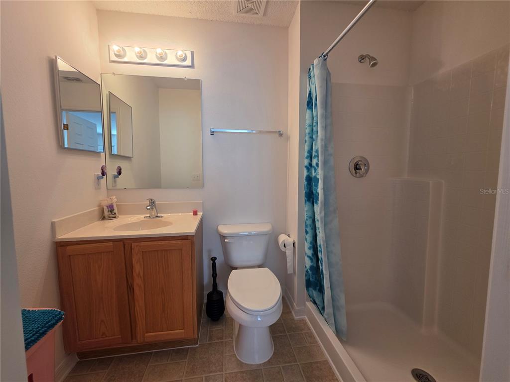 9276 Elm Court Spring Hill, FL 34606 - Photo 21 of 35 a bathroom with a sink a toilet and shower