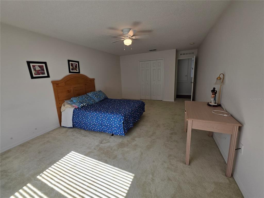 9276 Elm Court Spring Hill, FL 34606 - Photo 23 of 35 a living room with furniture and a chandelier