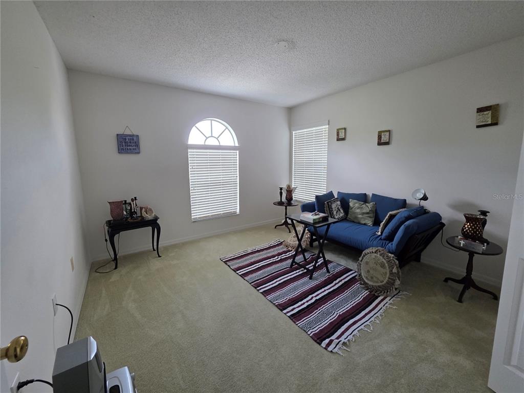 9276 Elm Court Spring Hill, FL 34606 - Photo 24 of 35 a living room with furniture a window and a potted plant