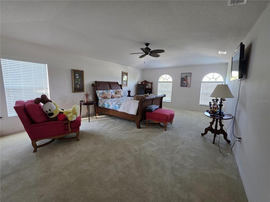 9276 Elm Court Spring Hill, FL 34606 - Photo 26 of 35 a living room with furniture and a flat screen tv