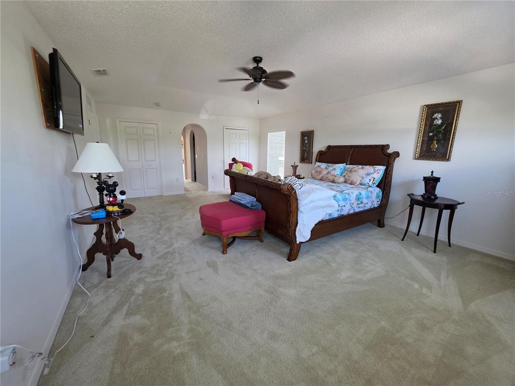9276 Elm Court Spring Hill, FL 34606 - Photo 27 of 35 a bed room with furniture and a flat screen tv