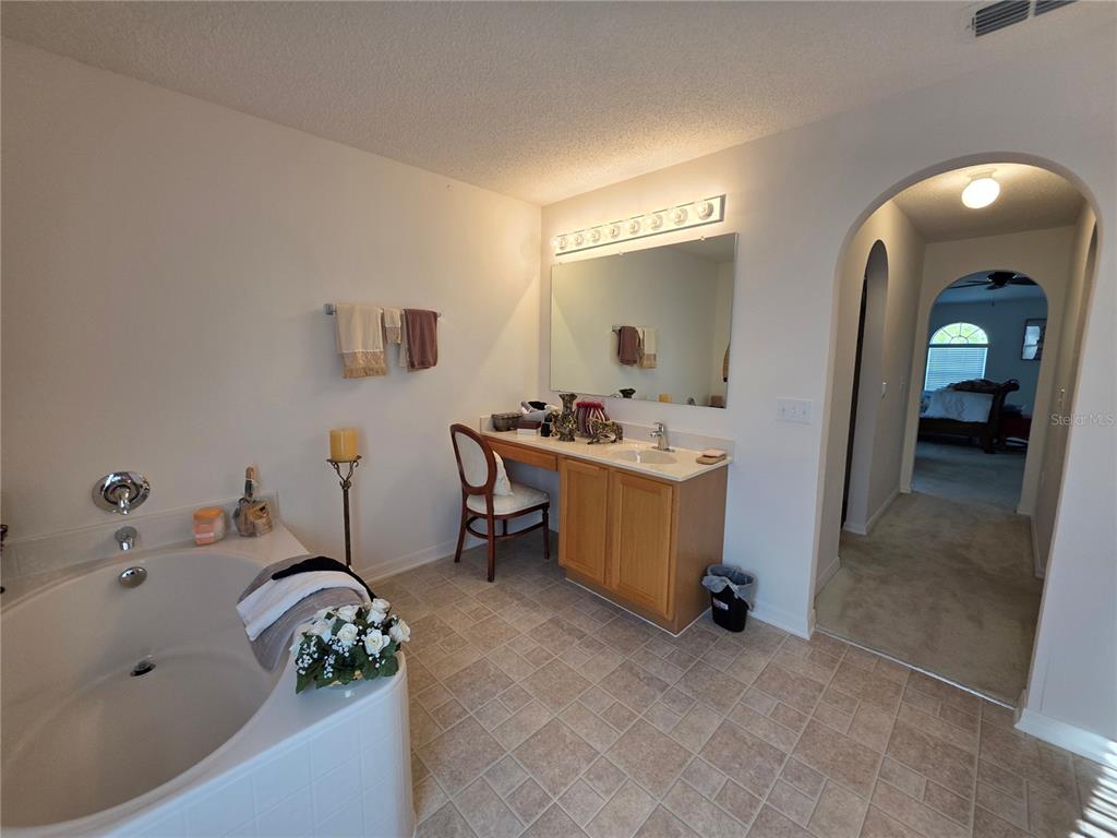 9276 Elm Court Spring Hill, FL 34606 - Photo 28 of 35 a bathroom with a tub sink and mirror