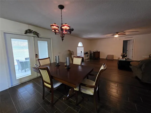 a view of a dining room with furniture wooden floor and chandelier