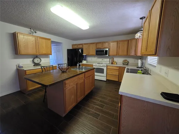 a kitchen with a sink a stove and cabinets