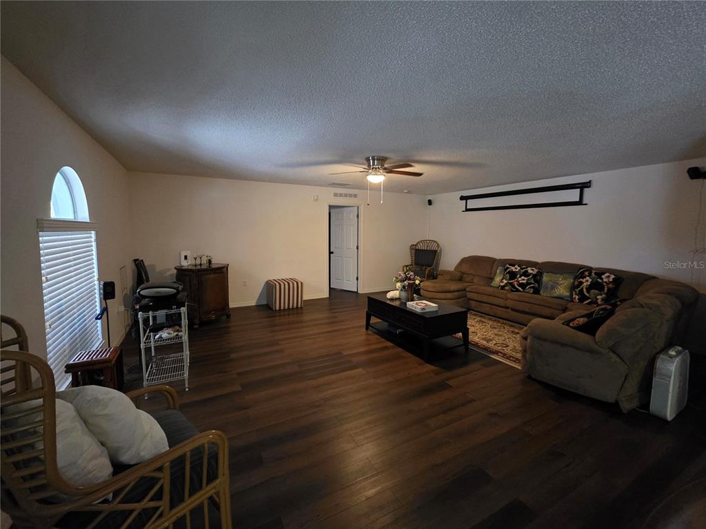 9276 Elm Court Spring Hill, FL 34606 - Photo 9 of 35 a living room with furniture and wooden floor