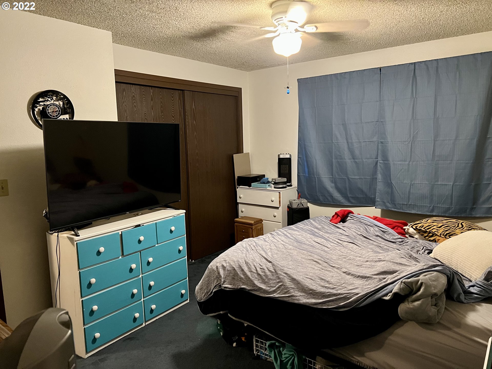 716 Southeast 10th Street Pendleton, OR 97801 - Photo 14 of 18 a bedroom with a bed and a flat tv screen on dresser