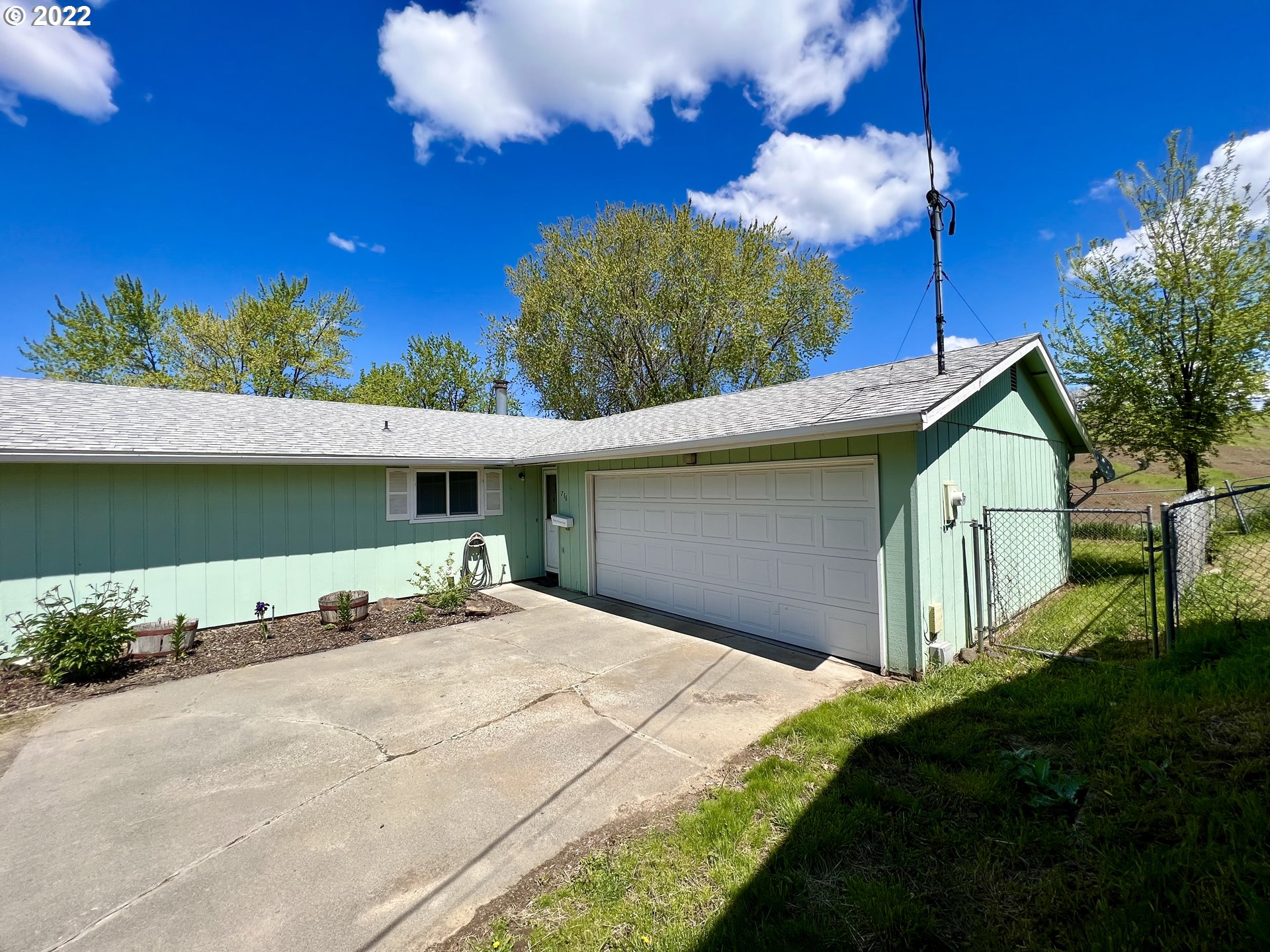 716 Southeast 10th Street Pendleton, OR 97801 - Photo 2 of 18 a front view of a house with a yard and garage