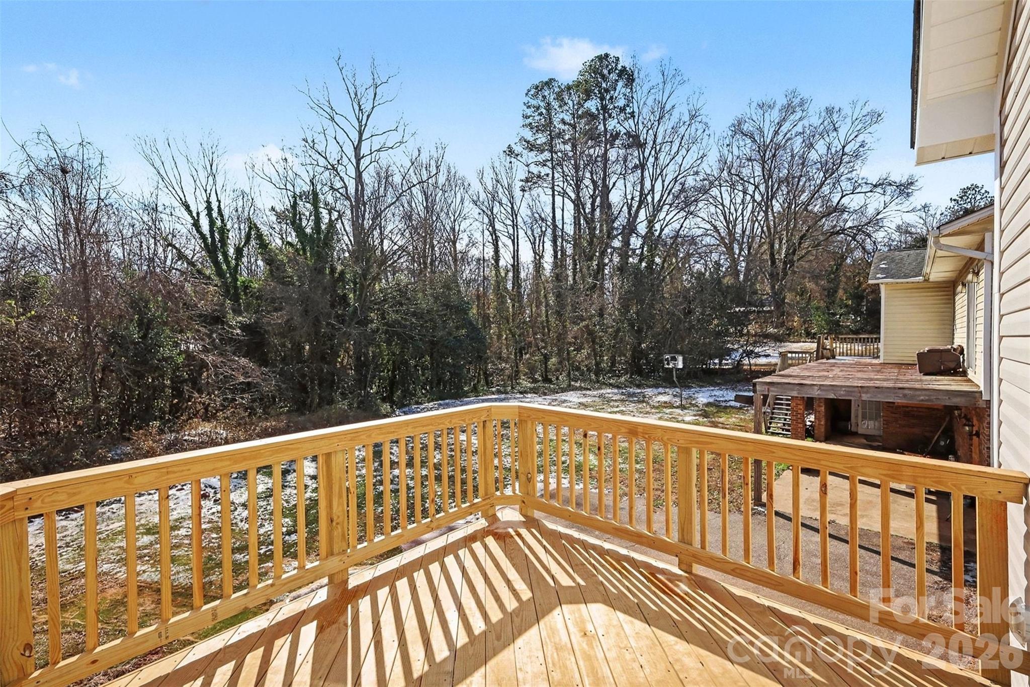 508 Mill Street Lowell, NC 28098 - Photo 24 of 27 a view of a balcony with wooden floor and fence