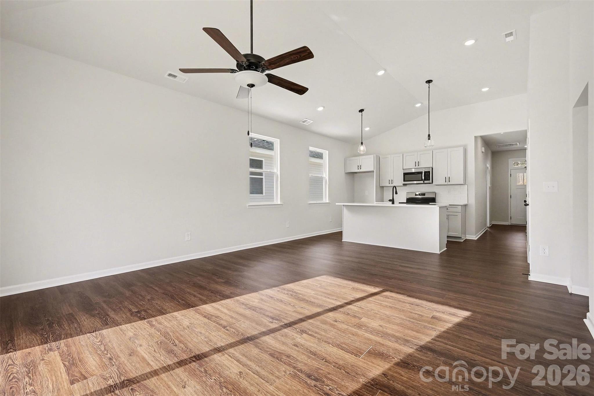 508 Mill Street Lowell, NC 28098 - Photo 6 of 27 a view of a kitchen with wooden floor and a kitchen