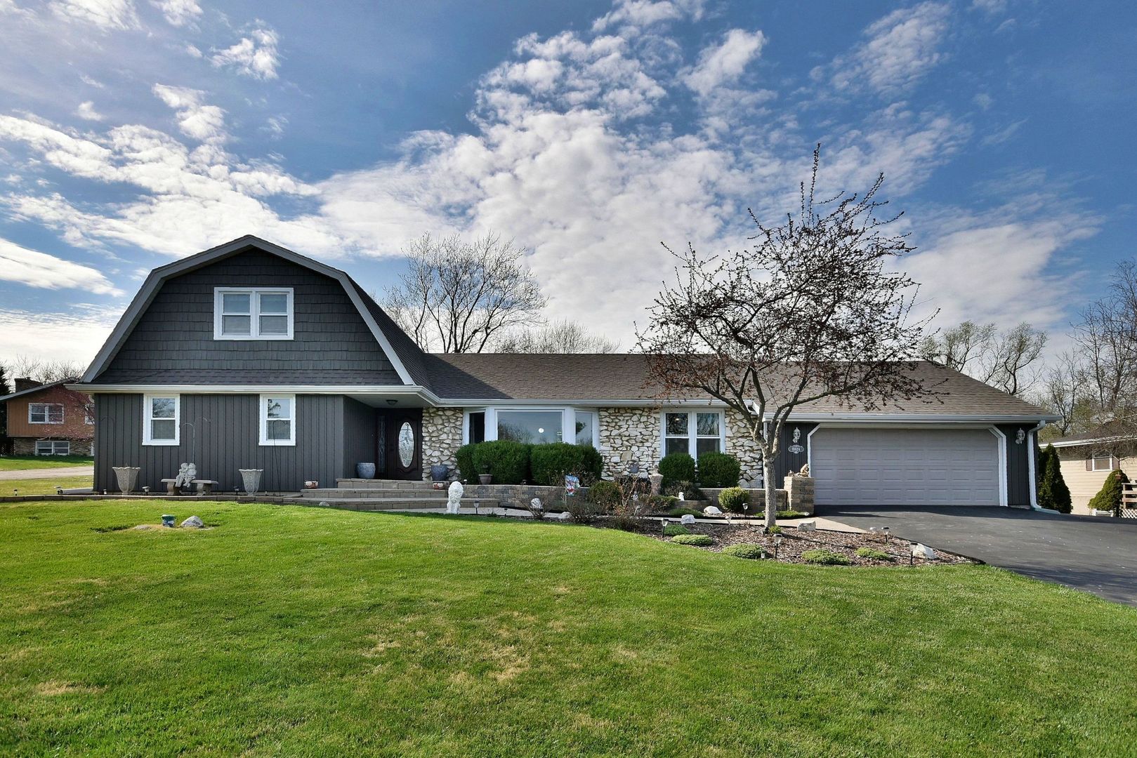 a front view of house with yard and green space