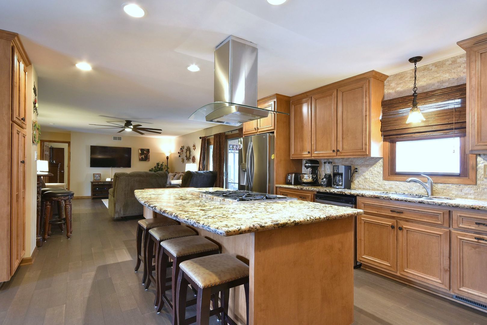 18824 Ruth Drive Mokena, IL 60448 - Photo 13 of 29 a kitchen with kitchen island granite countertop a table chairs sink and cabinets
