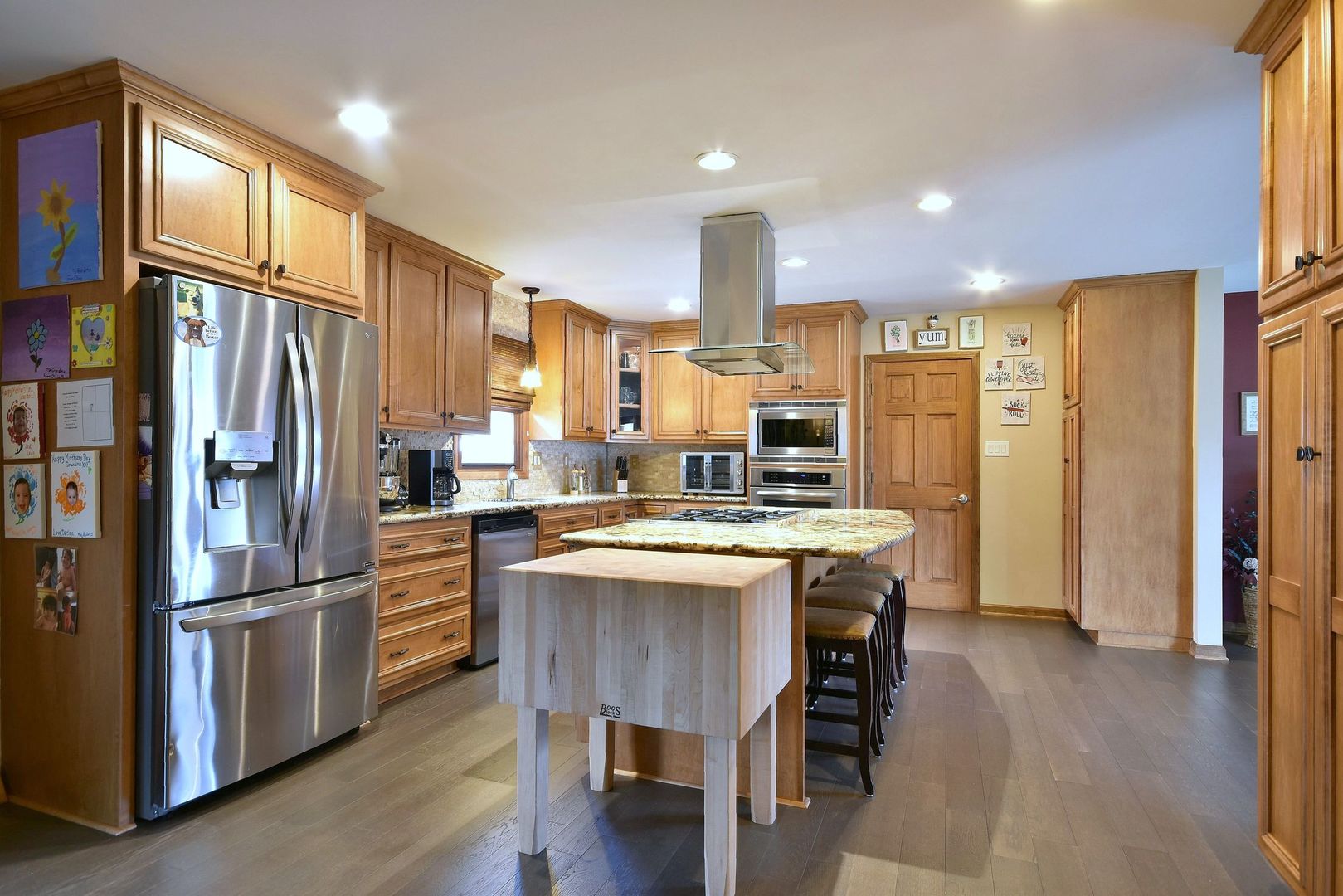 18824 Ruth Drive Mokena, IL 60448 - Photo 14 of 29 a kitchen with stainless steel appliances granite countertop a refrigerator a stove a sink a dining table and chairs with wooden floor