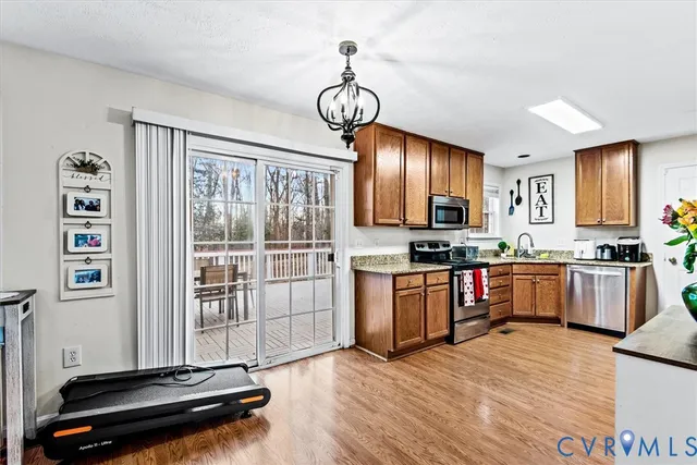 a view of a livingroom with furniture wooden floor and windows