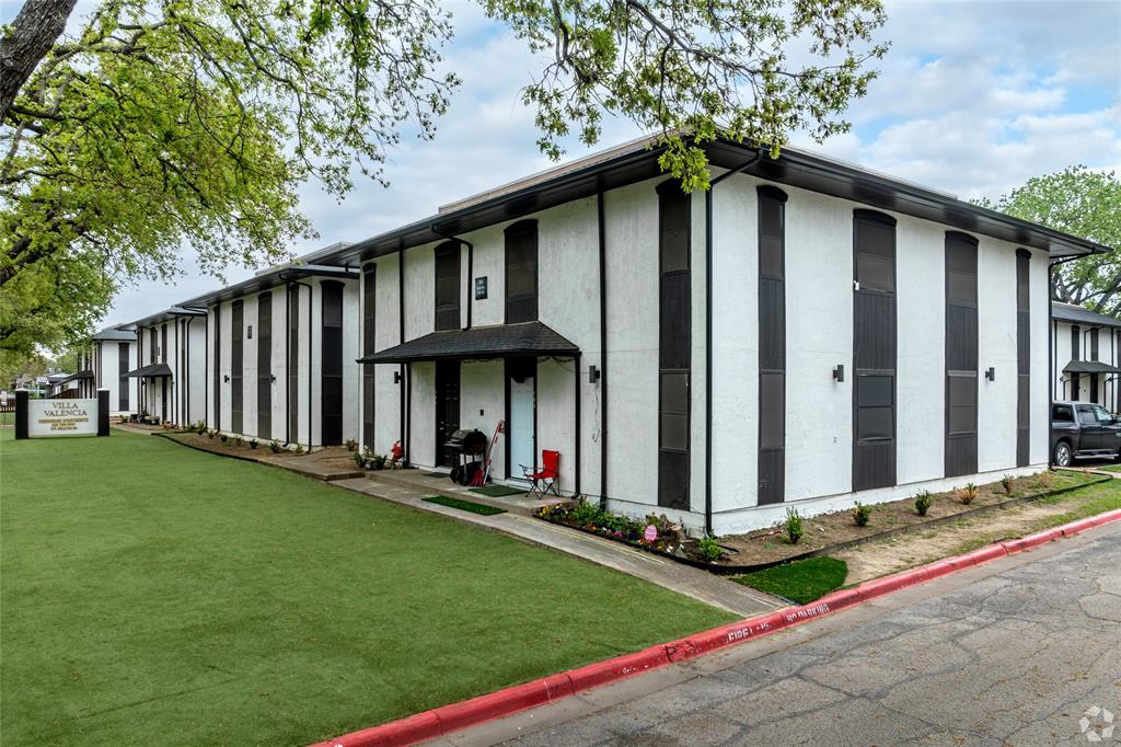 White stucco exterior with black trim, presenting a modern aesthetic