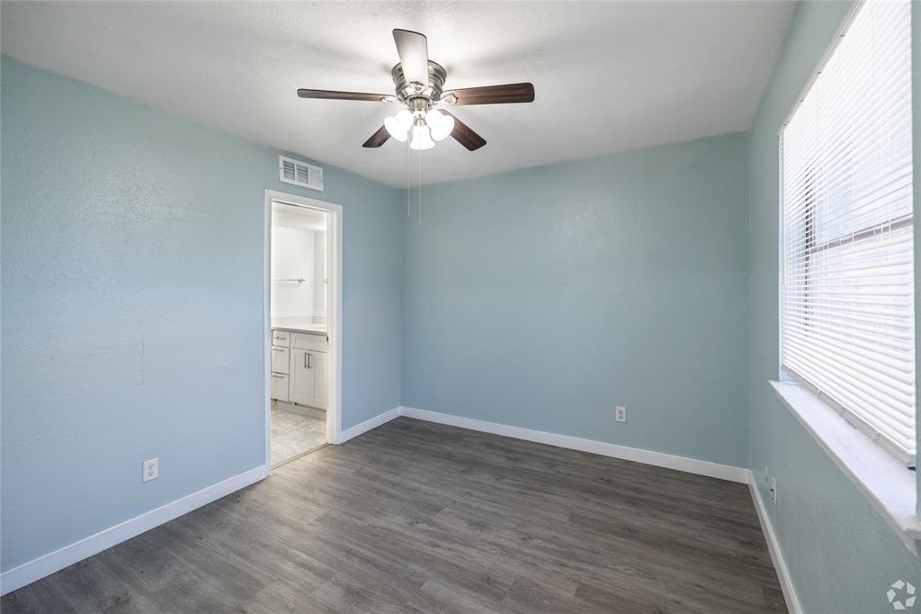 313 Rolston Road, Unit 315102 Irving, TX 75060 - Photo 4 of 8 Spacious room featuring wood-finish flooring, light blue walls, and a ceiling fan with integrated lighting