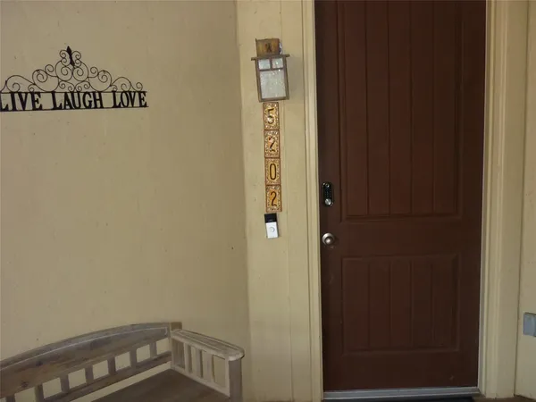a view of hallway with wooden wall