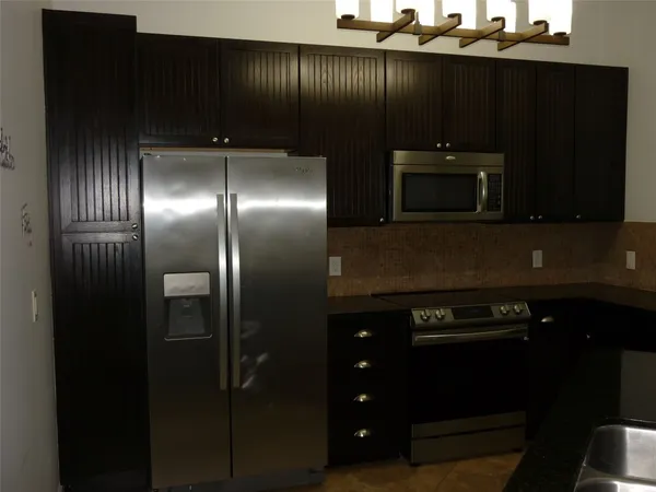 a kitchen with a refrigerator and cabinets
