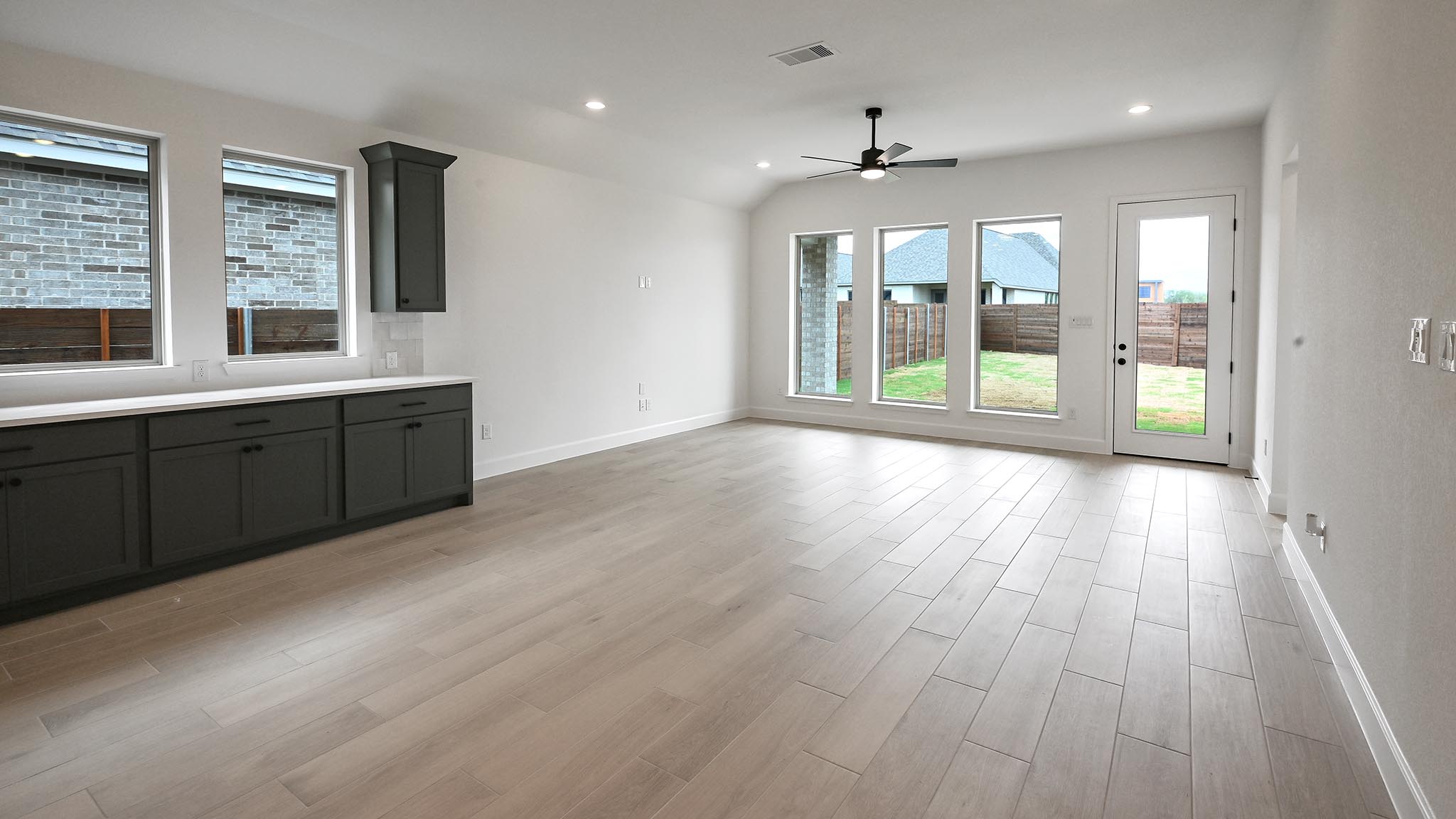 3921 Melody Road Lockhart, TX 78644 - Photo 12 of 30 a view of an empty room with wooden floor and a window