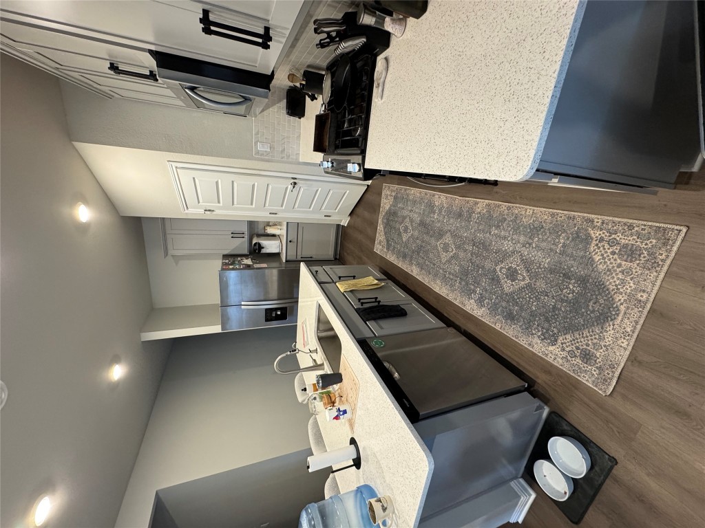 429 El Capitan Loop Dripping Springs, TX 78620 - Photo 11 of 18 Open kitchen with large island and stainless steel appliances