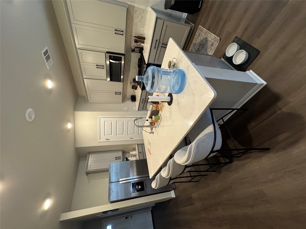 429 El Capitan Loop Dripping Springs, TX 78620 - Photo 12 of 18 Open kitchen with large island and stainless steel appliances