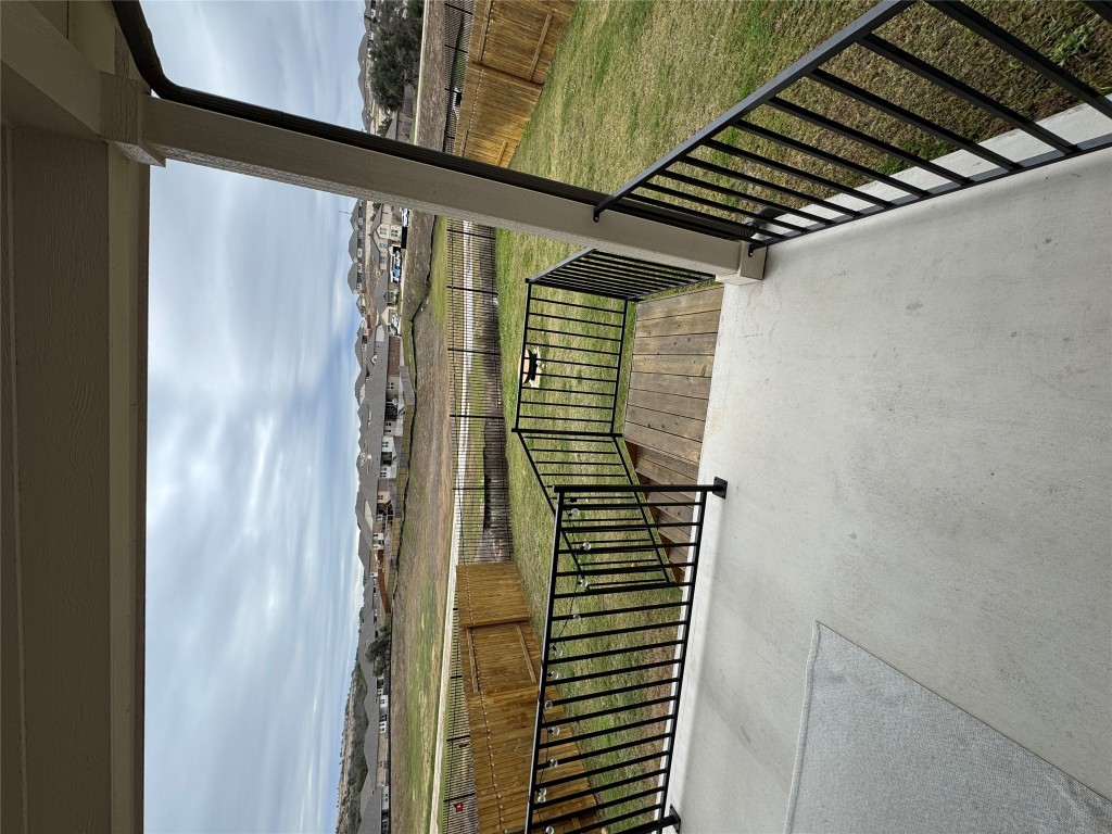 429 El Capitan Loop Dripping Springs, TX 78620 - Photo 16 of 18 Backyard patio featuring overlooking a grassy fenced-in yard