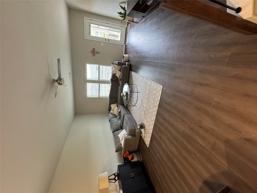 429 El Capitan Loop Dripping Springs, TX 78620 - Photo 9 of 18 Spacious living room with dark wood finished flooring