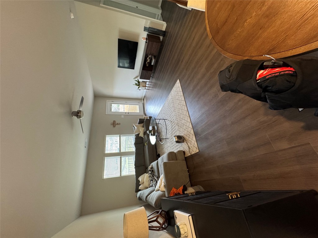 429 El Capitan Loop Dripping Springs, TX 78620 - Photo 10 of 18 Spacious living room with dark wood finished flooring