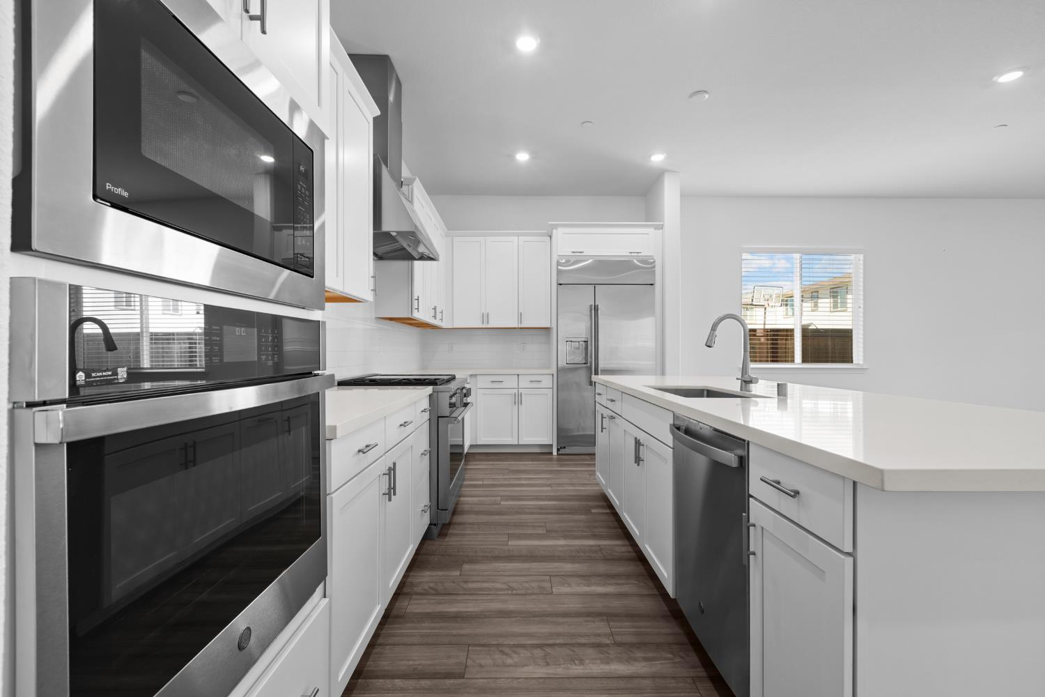 4236 Bellwether Way Sacramento, CA 95835 - Photo 1 of 57 a large kitchen with stainless steel appliances kitchen island a stove and a sink