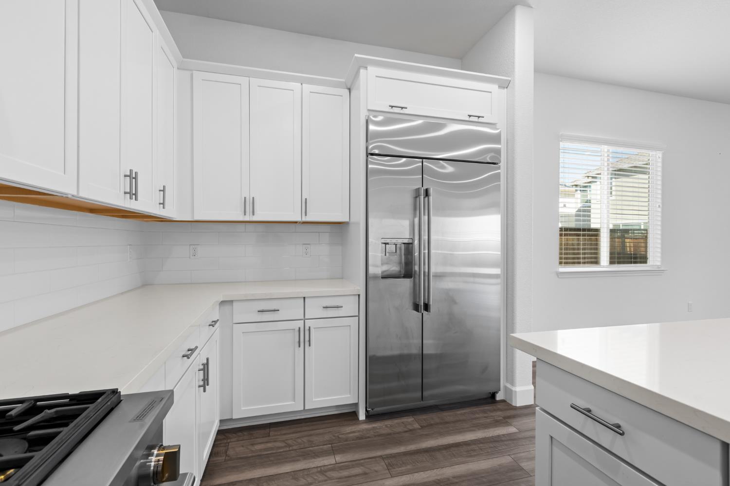 4236 Bellwether Way Sacramento, CA 95835 - Photo 12 of 57 a kitchen with a refrigerator and white cabinets
