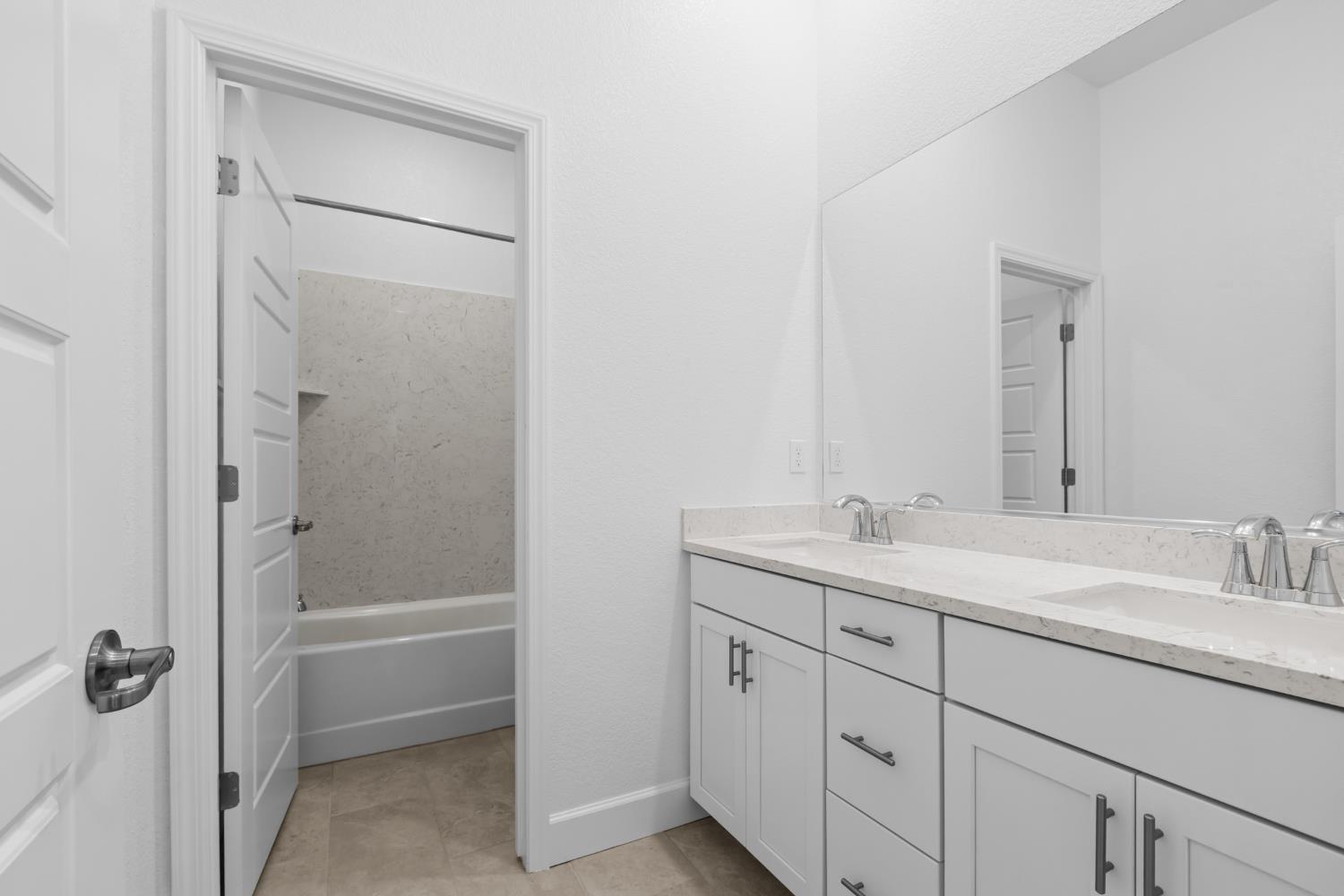 4236 Bellwether Way Sacramento, CA 95835 - Photo 22 of 57 a bathroom with a granite countertop sink a toilet and a mirror