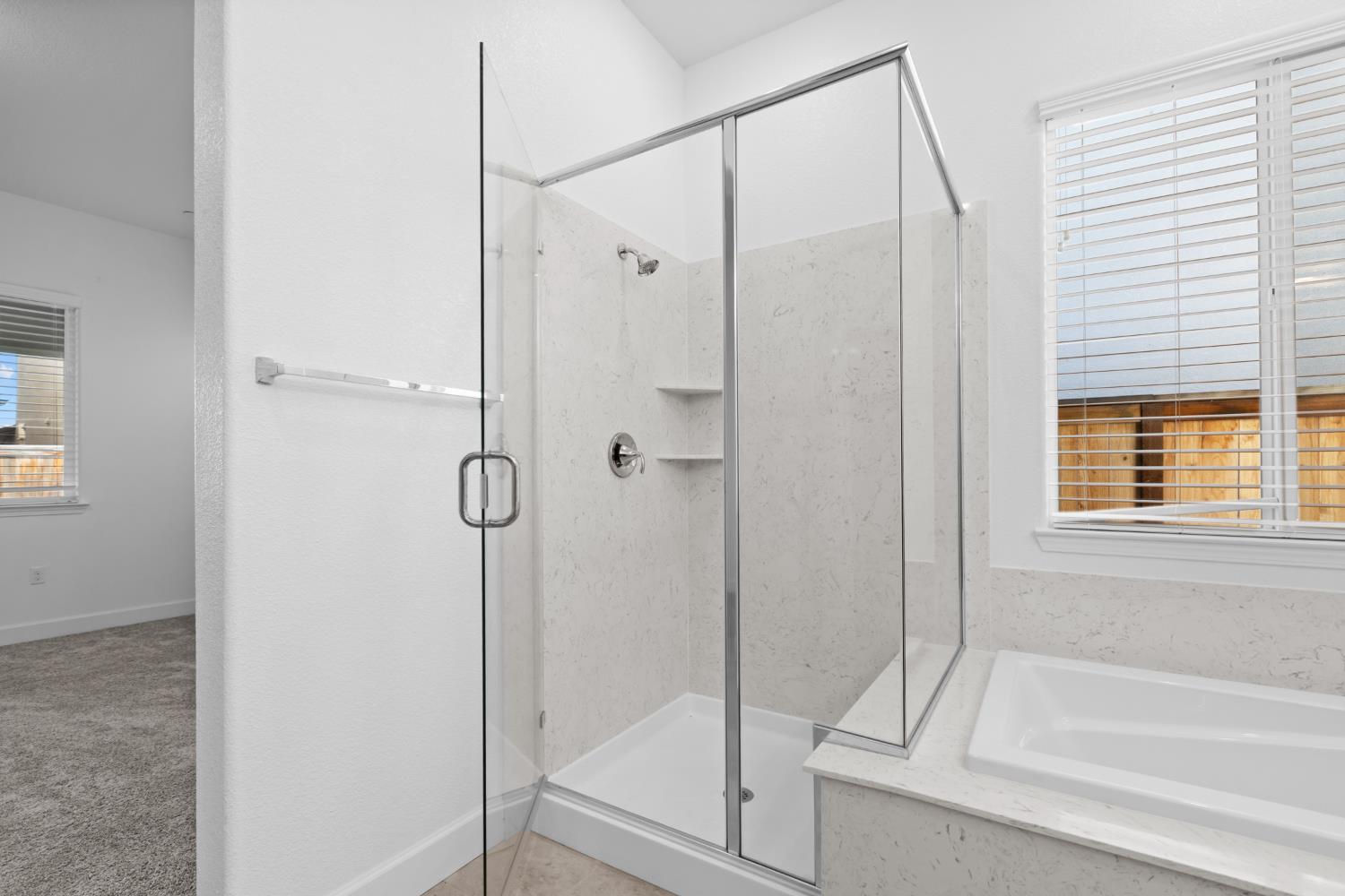 4236 Bellwether Way Sacramento, CA 95835 - Photo 23 of 57 a bathroom with a glass shower door