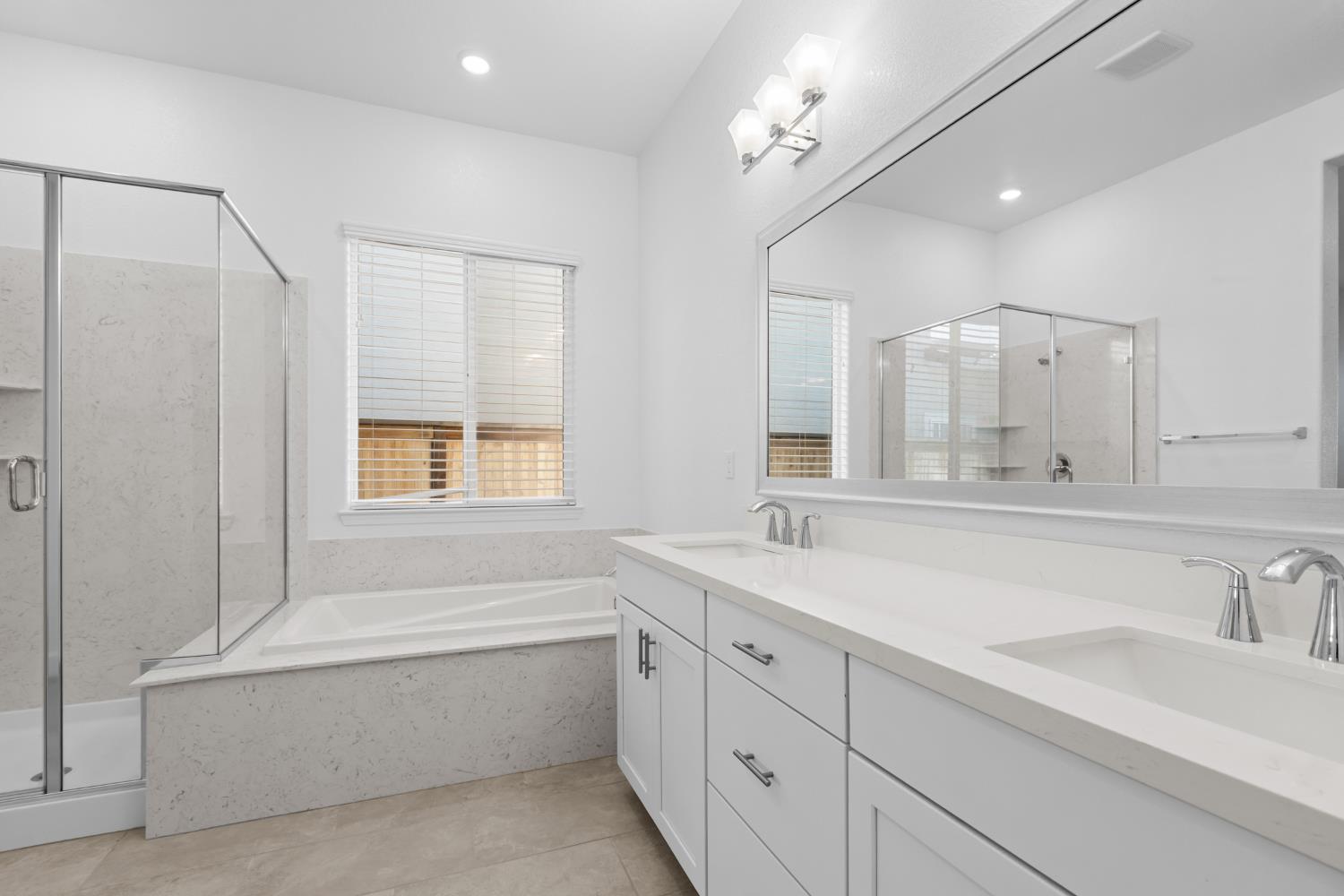 4236 Bellwether Way Sacramento, CA 95835 - Photo 24 of 57 a bathroom with a tub sink and mirror