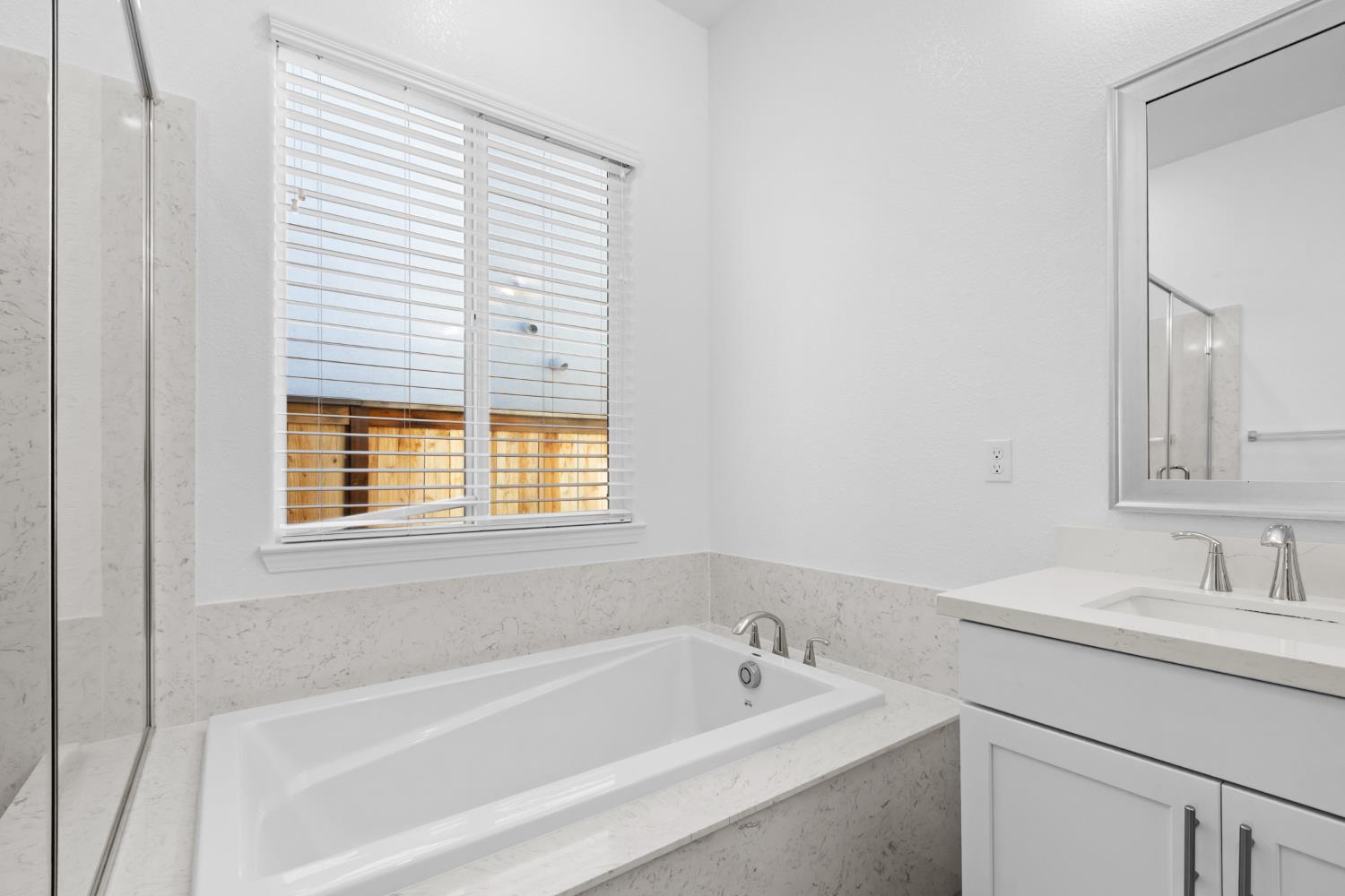 4236 Bellwether Way Sacramento, CA 95835 - Photo 25 of 57 a white bath tub sitting next to a white sink